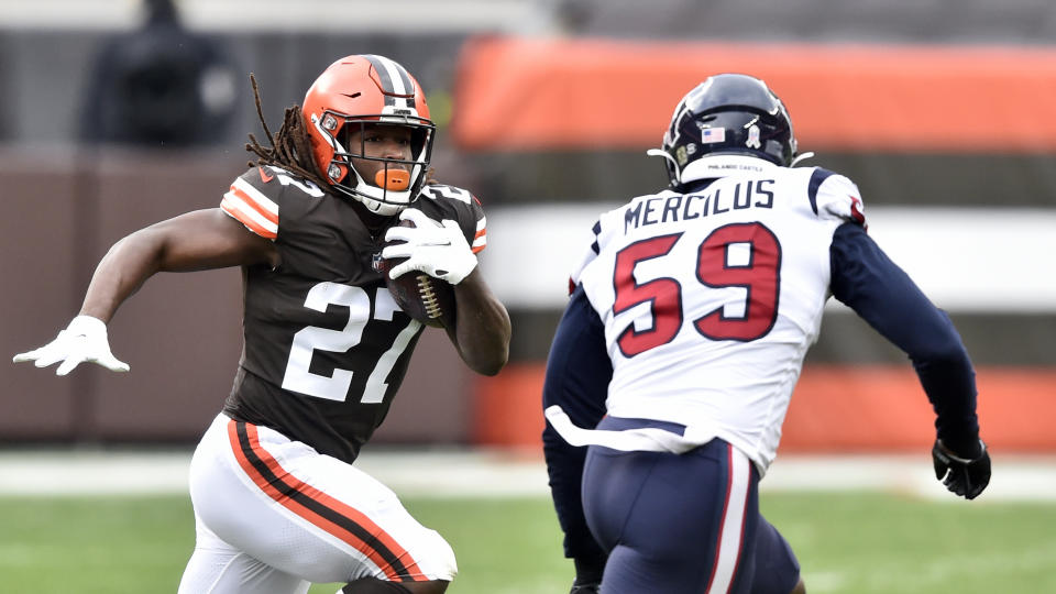 Cleveland Browns running back Kareem Hunt (27) rushes against Houston Texans outside linebacker Whitney Mercilus (59) during the first half of an NFL football game, Sunday, Nov. 15, 2020, in Cleveland. (AP Photo/David Richard)