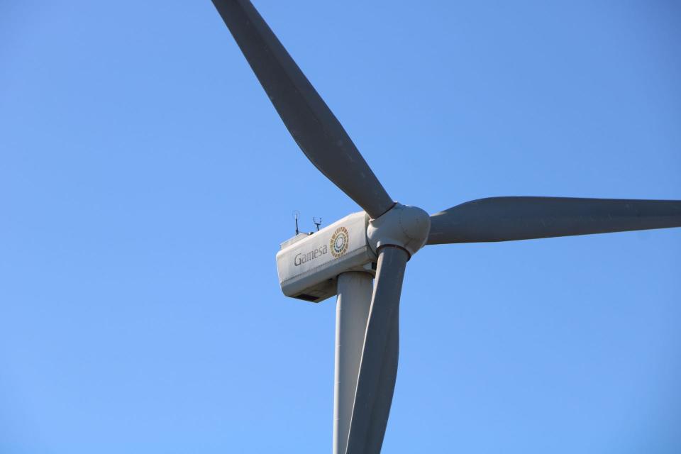 A small two megawatt wind turbine spins above the University of Delaware campus in Lewes, Delaware.
