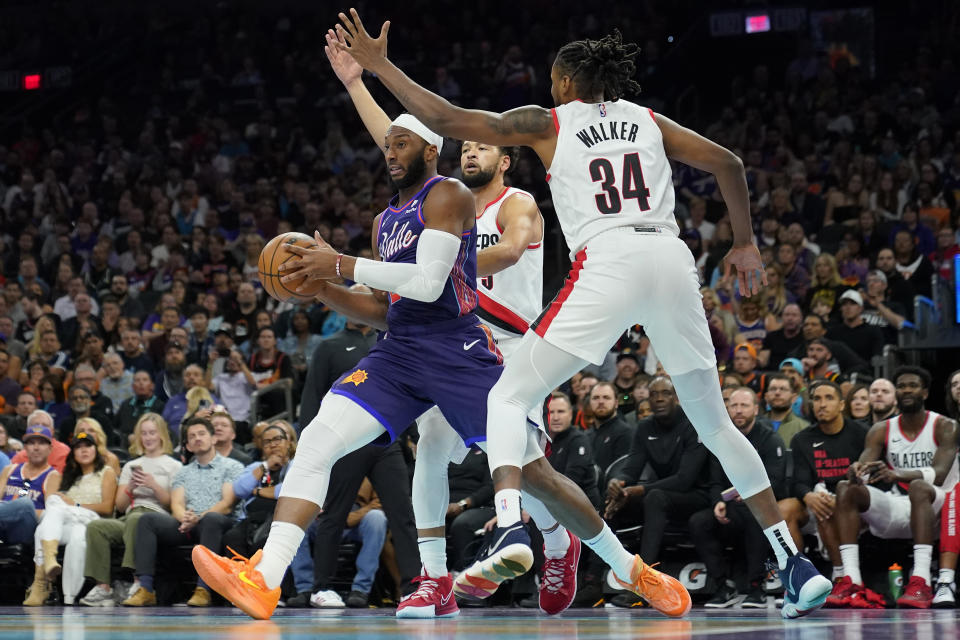 Phoenix Suns forward Josh Okogie drives past Portland Trail Blazers forward Jabari Walker (34) during the second half of an NBA In-Season Tournament basketball game, Tuesday, Nov. 21, 2023, in Phoenix. (AP Photo/Matt York)