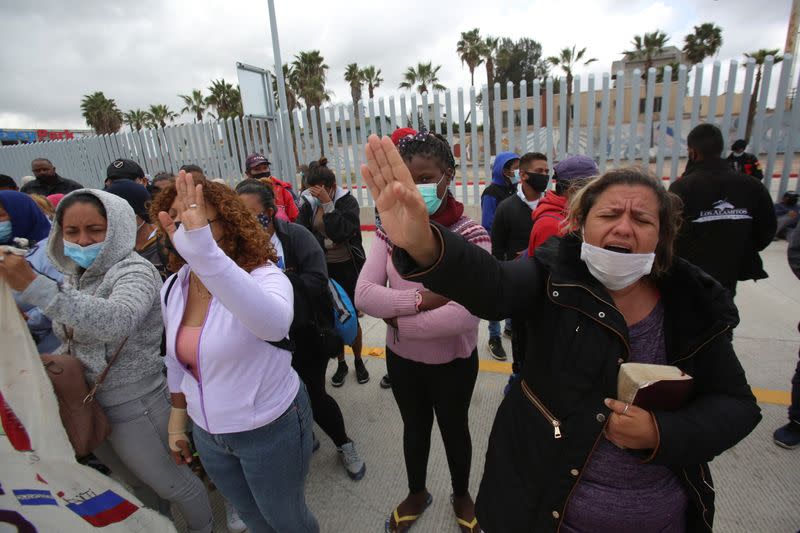 Asylum-seeking migrants from Mexico and Central America pray near the San Ysidro Port of Entry with the U.S., in Tijuana
