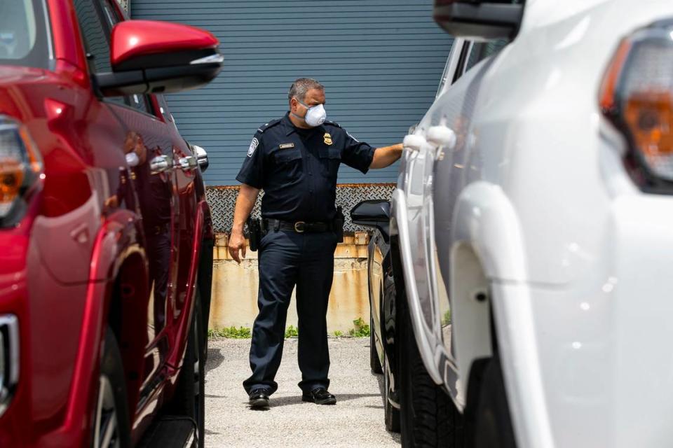 Dylan DeFrancisci, port director for U.S. Customs and Border Protection, looks at more than 80 vehicles seized by Homeland Security Investigations at Port Everglades on Tuesday, July 7, 2020. The vehicles, worth $3.2 million, were being shipped from Port Everglades to Venezuela. The cars, allegedly bought by a ring associated with the government of Venezuelan President Nicolas Maduro, were intercepted by Customs and Border Protection.