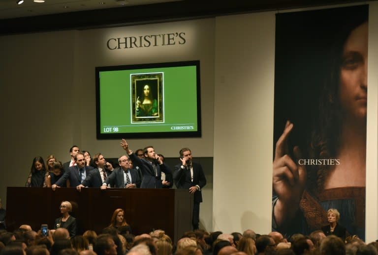 Christie's employees take bids for Leonardo da Vinci’s "Salvator Mundi" at Christie's New York on November 15, 2017.A 500-year-old work of art depicting Jesus Christ, believed to be the work of Renaissance master Leonardo da Vinci, sold in New York on Wednesday for $450.3 million setting a new art auction record, Christie's said "Salvator Mundi," which the auction house dates back to around 1500, sold after 18 minutes of frenzied bidding in a historic sale, the star lot of the November art season in the US financial capital