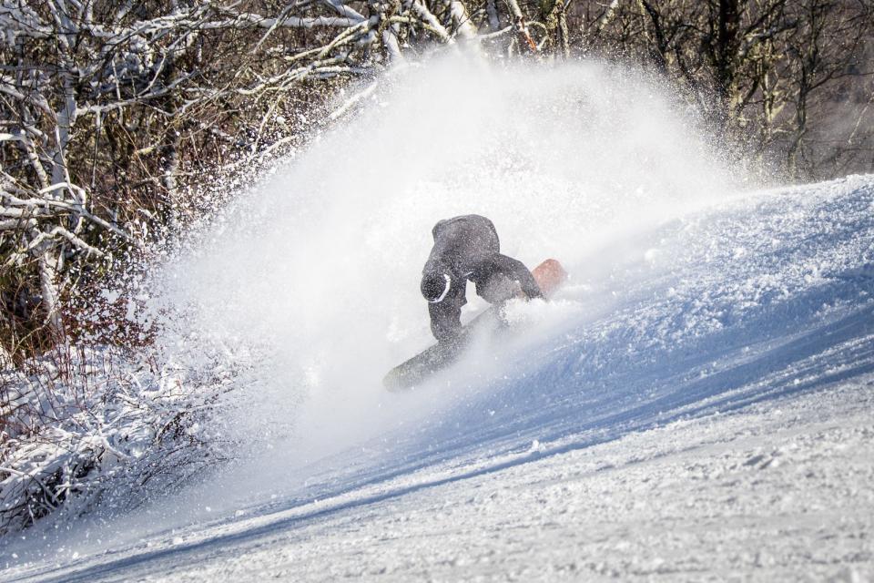 In this file photo, a snowboarder makes some afternoon turns on the Switchback slope at Sugar Mountain Ski Resort, Nov. 25 2019.