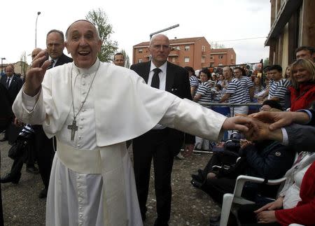 Pope Francis shakes hands to crowd after a meeting with the people affected by the earthquake in Mirandola, Italy, April 2, 2017. REUTERS/Alessandro Garofalo