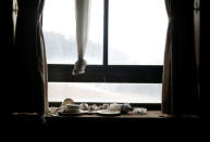 Light bulbs, bowls and plates lie on a windowsill at the abandoned Alps Ski Resort located near the demilitarised zone separating the two Koreas in Goseong, South Korea, January 17, 2018. REUTERS/Kim Hong-Ji