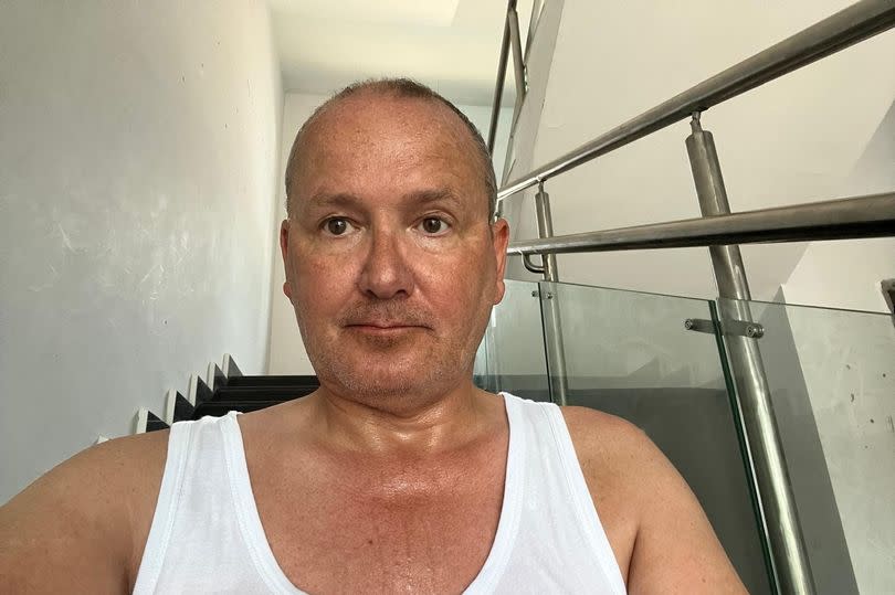 Disabled Ian Molland is stuck in India due to Dubai floods. -Credit:Ian Molland / SWNS