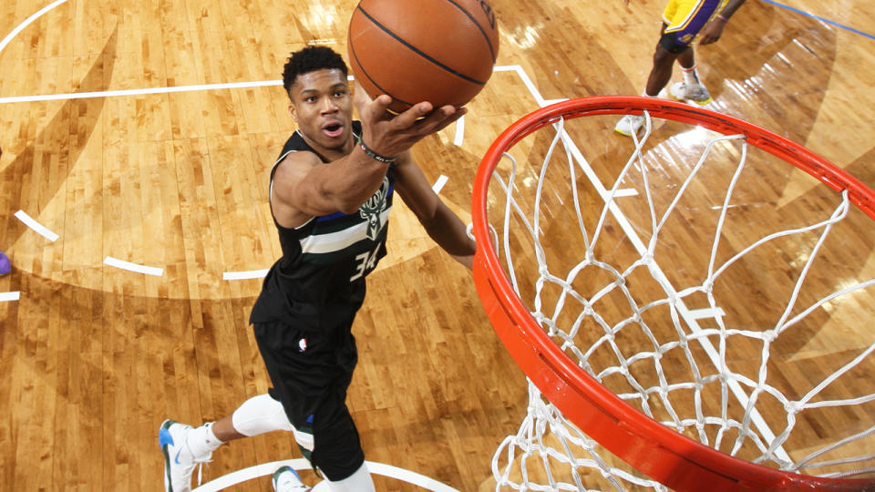 Giannis Antetokounmpo, pictured attempting a lay-up, helped Milwaukee to a win over the LA Lakers.