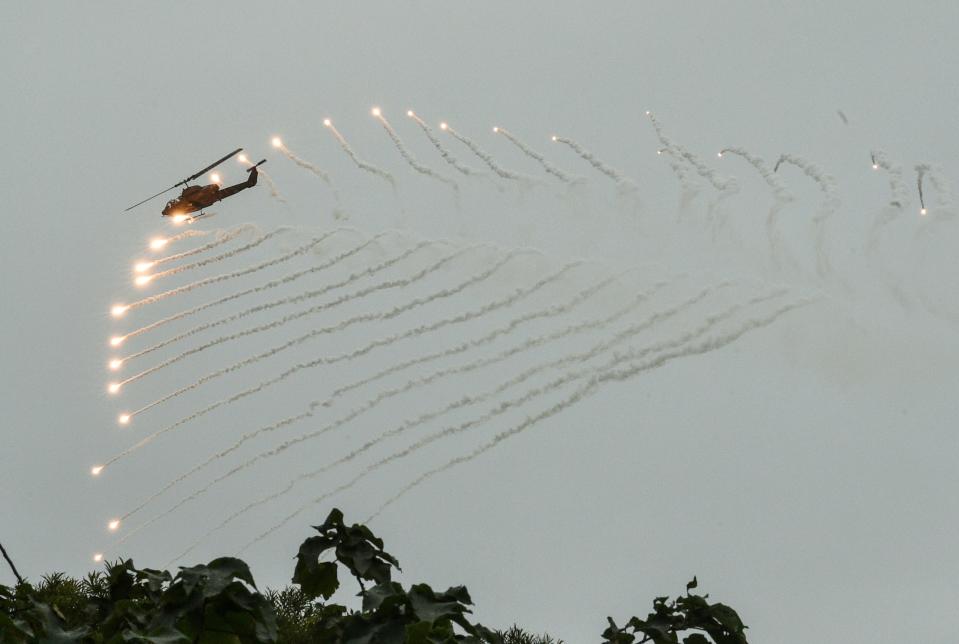 A US-made AH-1W Super Cobra helicopter launches flares during an annual drill at the a military base in the eastern city of Hualien on January 30, 2018.