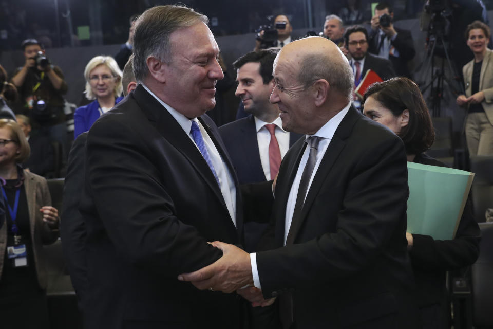 U.S. Secretary of State Mike Pompeo, left, shakes hands with France's Foreign Minister Jean-Yves Le Drian during a NATO Foreign Ministers meeting at the NATO headquarters in Brussels, Wednesday, Nov. 20, 2019. (AP Photo/Francisco Seco)