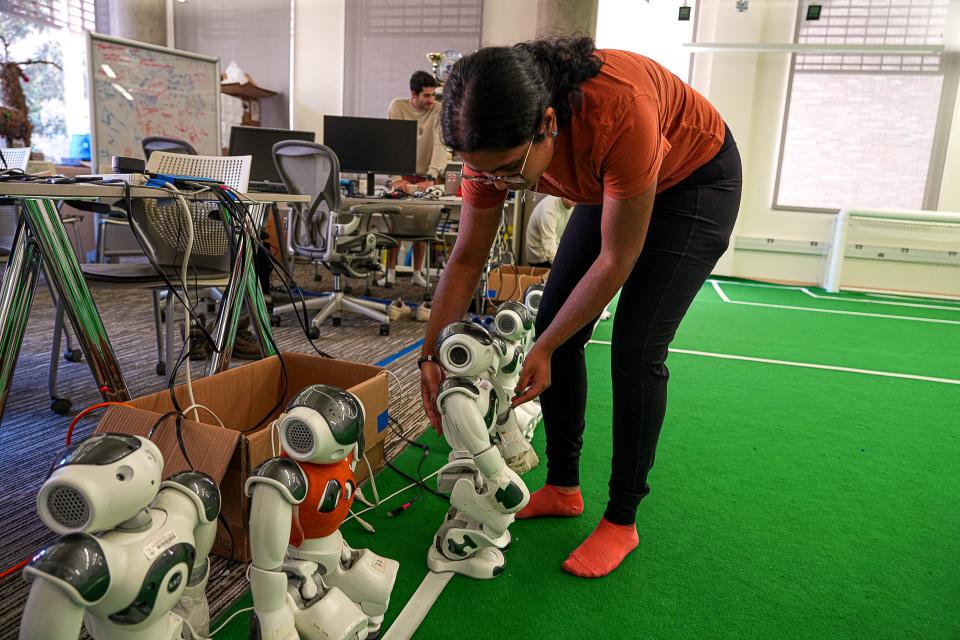 Geethika Hemkumar, a fifth-year integrated master's computer science student, moves a Texas Robotics RoboCup soccer team player. Hemkumar says she sees the future of robots as “collaborators” in people's lives.