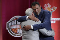 Inductee Vlade Divac, right, hugs his presenter, Jerry West, during the Basketball Hall of Fame enshrinement ceremony Friday, Sept. 6, 2019, in Springfield, Mass. (AP Photo/Elise Amendola)