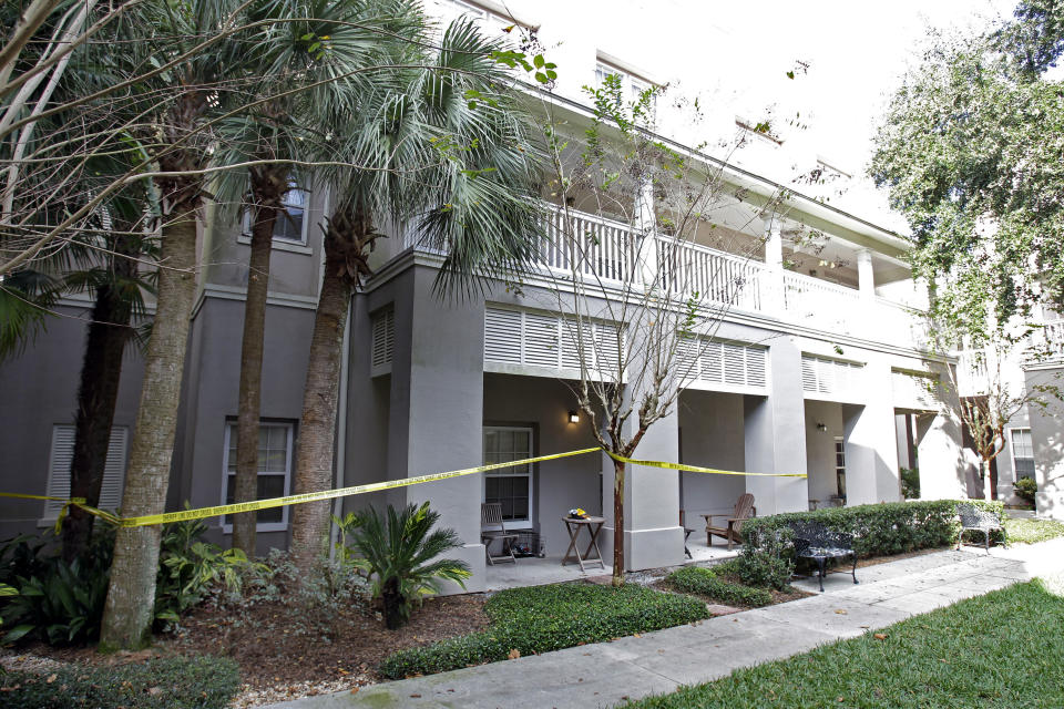 Crime scene tape surrounds a condominium, Wednesday, Dec. 1, 2010, where the first homicide has taken place in Celebration, Fla. The small town just south of Walt Disney World has never reported a homicide in its existence, until this week. (AP Photo/John Raoux)