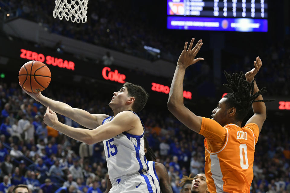 Kentucky guard Reed Sheppard (15) attempts a layup past Tennessee forward Jonas Aidoo (0) during the second half of an NCAA college basketball game in Lexington, Ky., Saturday, Feb. 3, 2024. Tennessee won 103-92. (AP Photo/Timothy D. Easley)