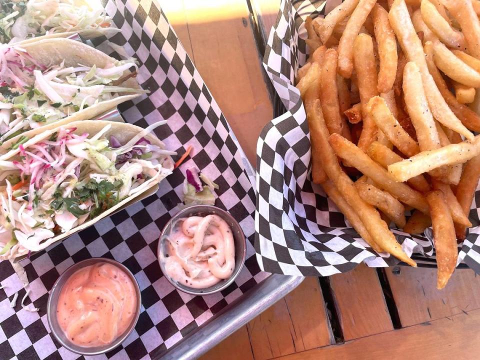 A French fry basket with peppercorn aioli and chiptole aioli with pork carnitas tacos with cabbage, radish, cilantro and jalapeño crema on corn tortillas at Twin Sisters Brewing Company in Bellingham, Wash. on Aug. 4, 2023.