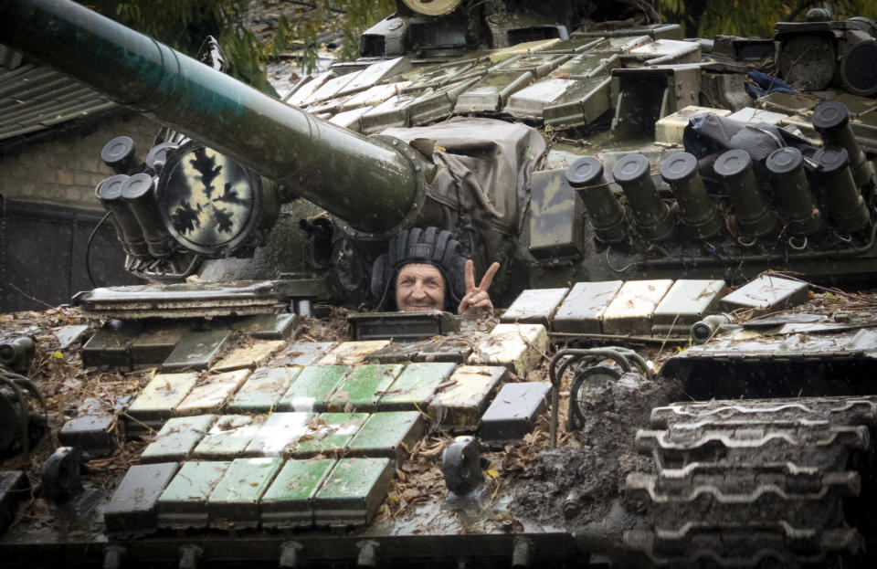 Ukrainian soldier flashes a victory sign in Bakhmut, the site of the heaviest battle against the Russian troops in the Donetsk region, Ukraine, Wednesday, Oct. 26, 2022. (AP Photo/Efrem Lukatsky)