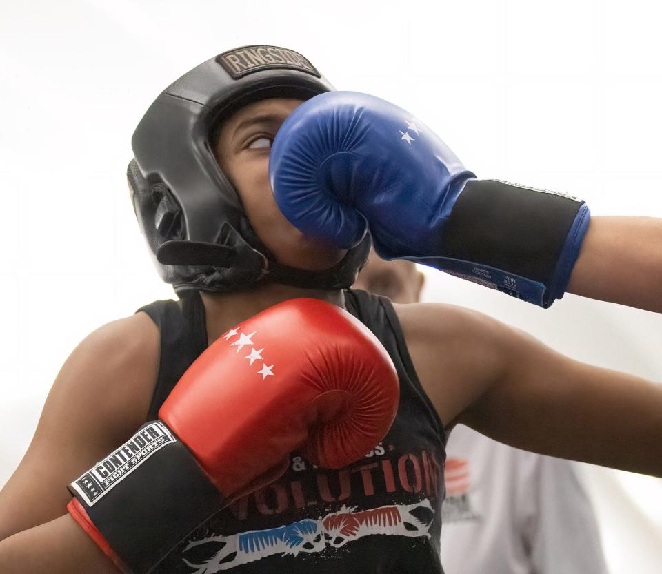 Lana Haines lands a punch on Shireh Abbas in the Intermediate title bout at the Brawl at the Hall of Fame Village on Saturday night.