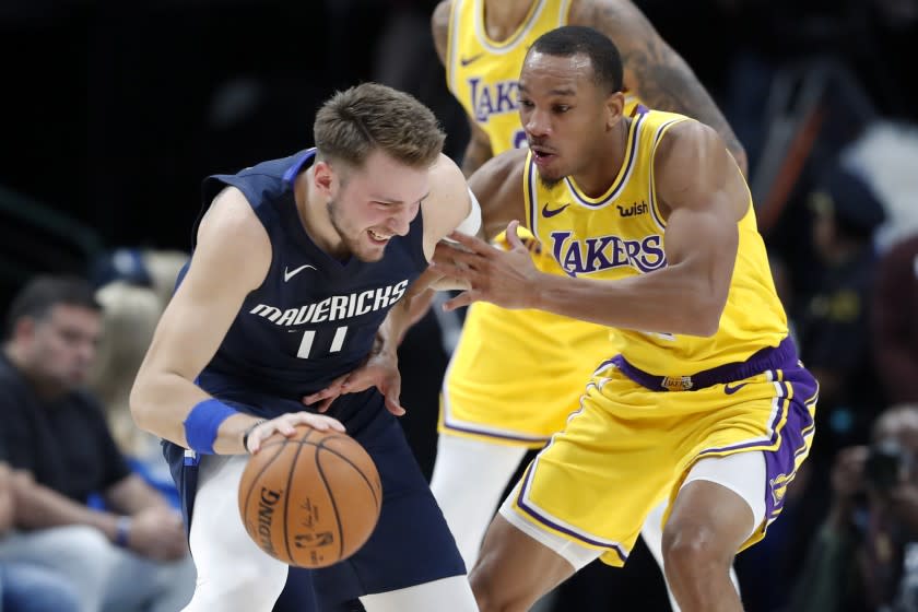 Dallas Mavericks' Luka Doncic, left, works against Los Angeles Lakers' Avery Bradley during the first half of an NBA basketball game in Dallas, Friday, Nov. 1, 2019. (AP Photo/Tony Gutierrez)