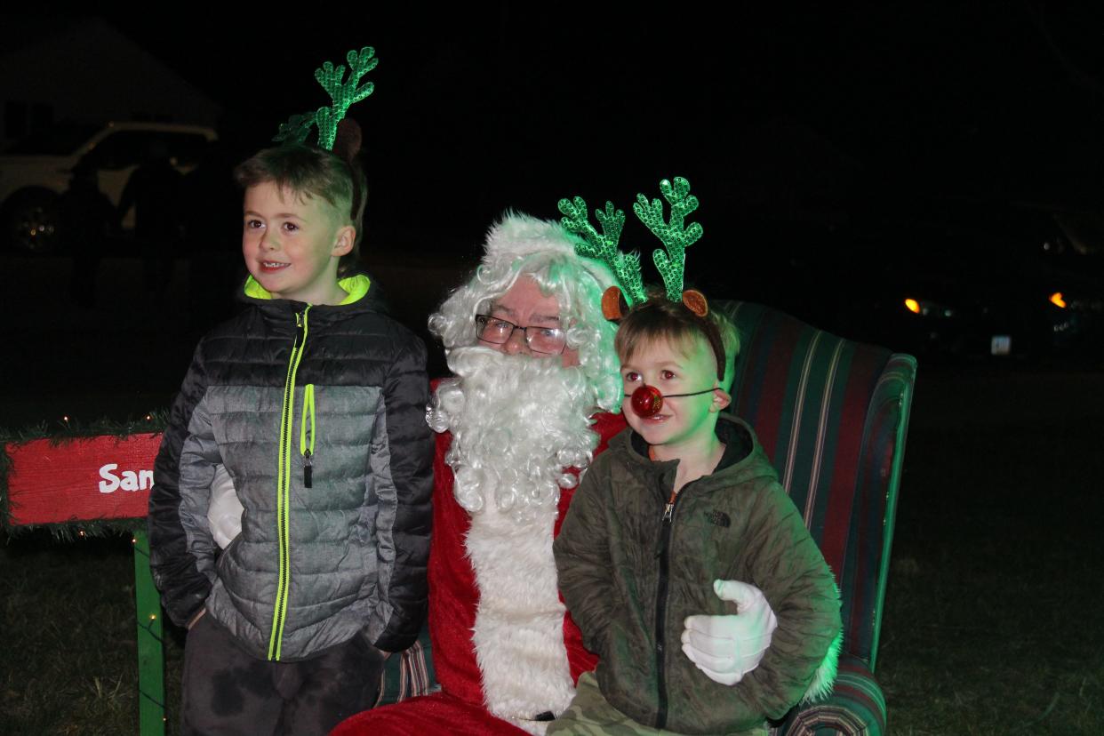 Roy Randall, 6, and Dean Randall, 4, pose for a photo with Santa Claus during the Holiday Tree Lighting on Saturday, Dec. 4, 2021, in Woodward.