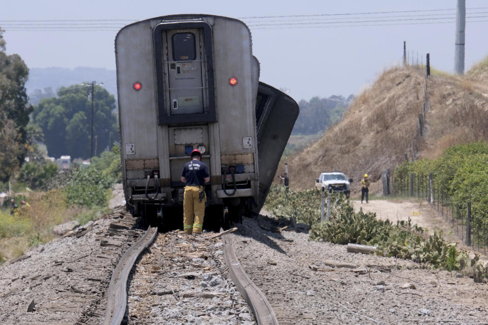 A derailed Amtrak train sits in Moorpark, Calif., on Wednesday, June 28, 2023. Authorities say an Amtrak passenger train carrying 190 passengers derailed after striking a vehicle on tracks in Southern California. Only minor injuries were reported. (Dean Musgrove/The Orange County Register via AP)