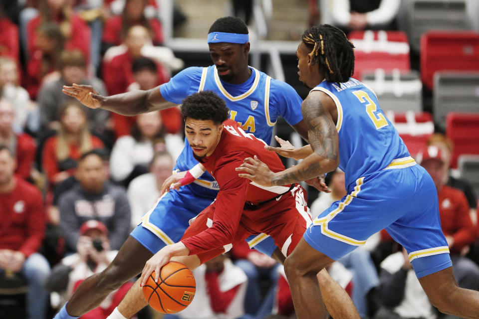 UCLA forward Adem Bona, top left, and guard Dylan Andrews, right, double-team Washington State guard Myles Rice, bottom left, during the first half of an NCAA college basketball game, Saturday, March 2, 2024, in Pullman, Wash. (AP Photo/Young Kwak)