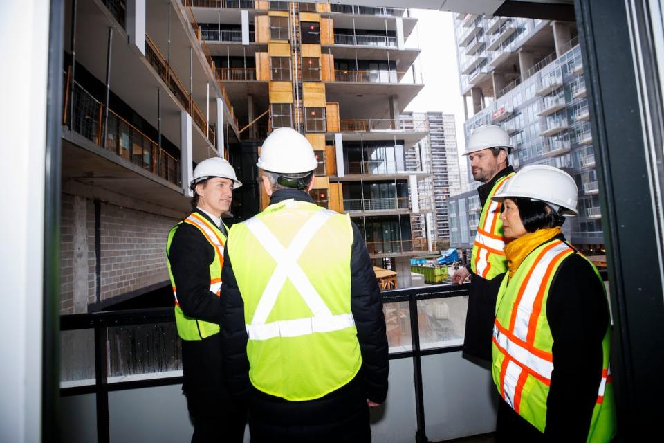 Prime Minister Justin Trudeau, alongside Housing Minister Sean Fraser (back right) and Toronto Mayor Olivia Chow (right), tours an under-construction condo tower in midtown Toronto, Wednesday, April 3, 2024.