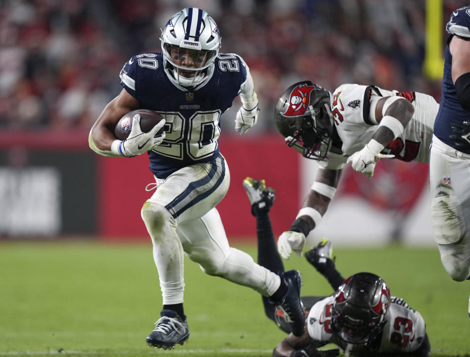 FILE - Dallas Cowboys running back Tony Pollard (20) runs for a first down during an NFL wild-card football game against the Tampa Bay Buccaneers, Monday, Jan. 16, 2023, in Tampa, Fla. The Dallas Cowboys placed their franchise tag on Tony Pollard on Monday, March 6, 2023, and still hope to work out a long-term deal with the running back who is coming off a breakout season. (AP Photo/Peter Joneleit, File)