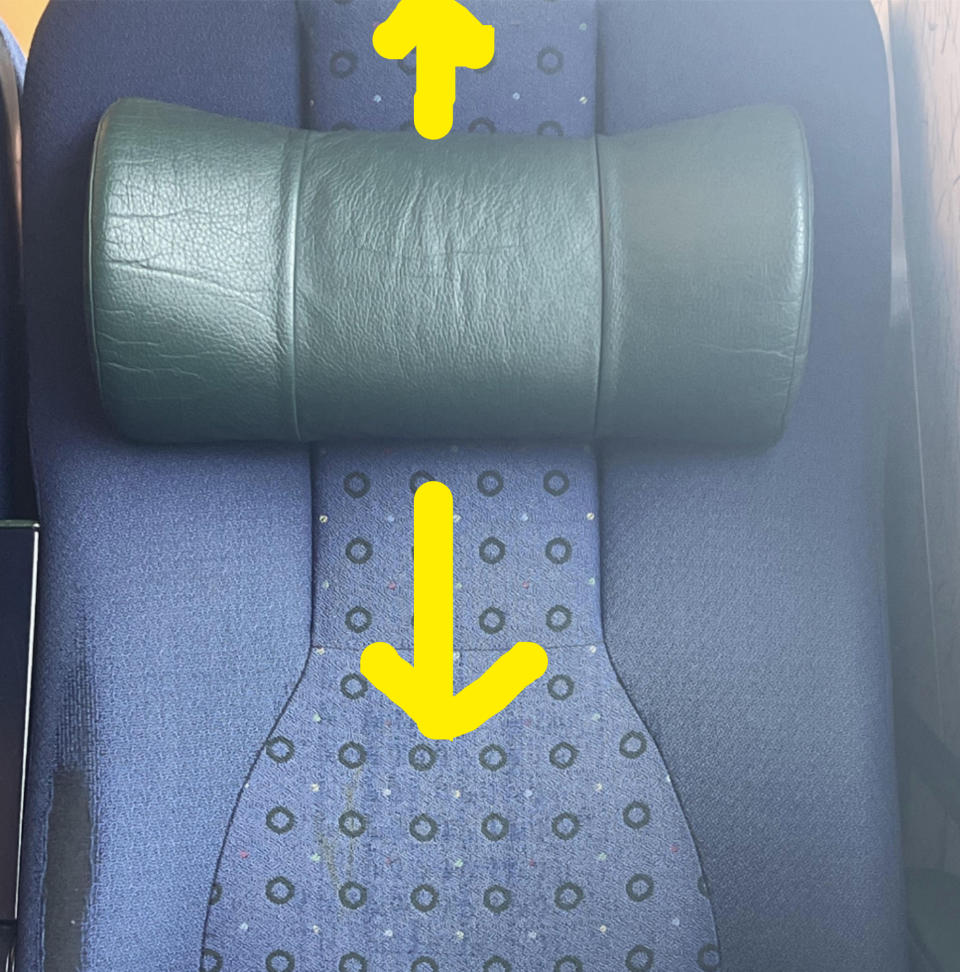 The seat has a headrest that is currently in the middle of the seat and be moved higher or lower, depending on the passenger's height