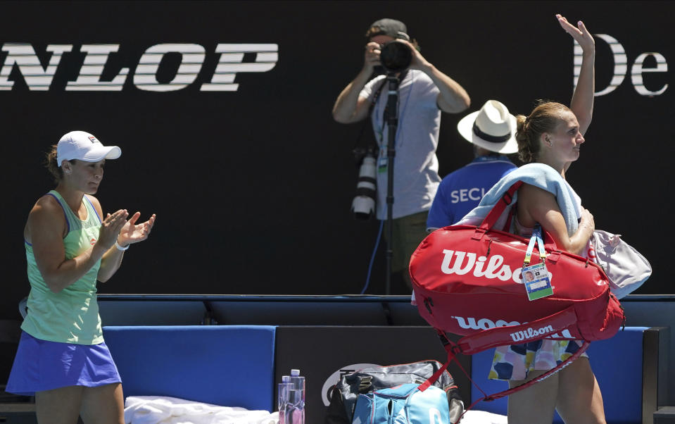 Australia's Ashleigh Barty, left, applauds as Petra Kvitova of the Czech Republic leaves Rod Laver Arena following their quarterfinal match at the Australian Open tennis championship in Melbourne, Australia, Tuesday, Jan. 28, 2020. (AP Photo/Lee Jin-man)