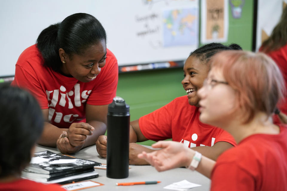 Program Director Olivia Ray, left, talks with students during a Lean In session at Girls Inc., Wednesday, July 26, 2023, in Sioux City, Iowa. A new girls leadership program from Lean In, the organization launched after Sheryl Sandberg published her book “Lean In: Women, Work and the Will to Lead,” will help girls respond to biases and gender inequities they may face. (AP Photo/Charlie Neibergall)