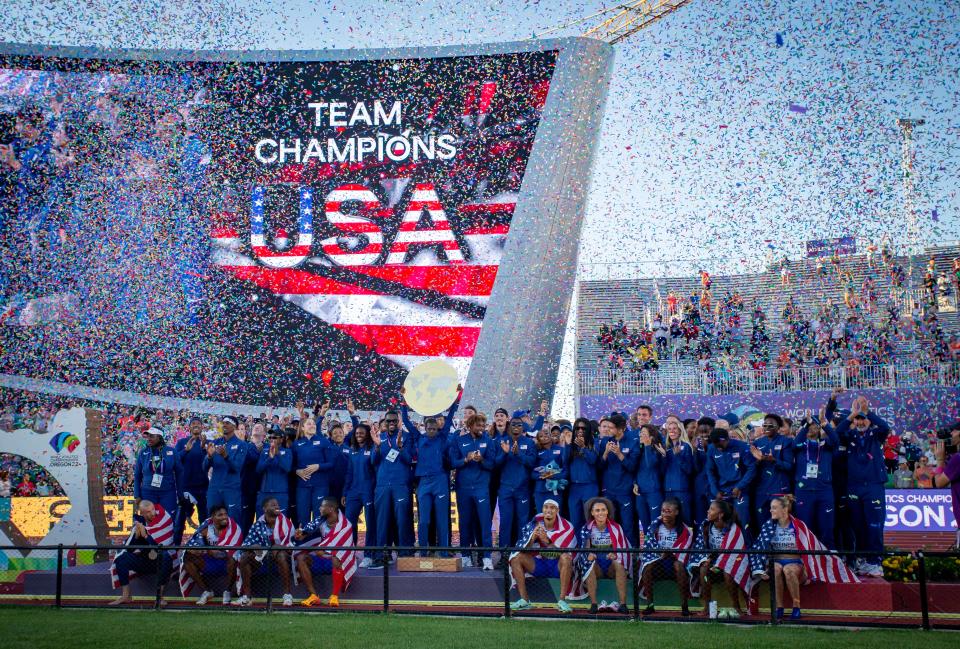 Members of Team USA celebrate after winning the team trophy on the final day of the World Athletics Championships on Sunday at Hayward Field in Eugene.