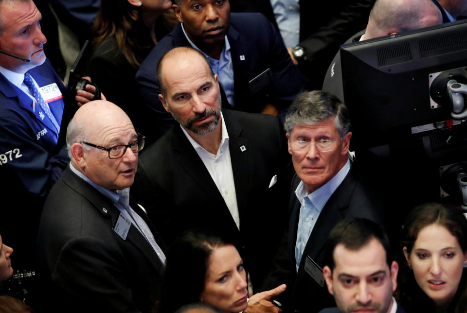 Uber Technologies Inc. CEO Dara Khosrowshahi, (C) Chairman Ronald Sugar (L) and Board Member John Thain (R) stand together on the trading floor of the New York Stock Exchange (NYSE) during the company's IPO in New York, U.S., May 10, 2019. REUTERS/Andrew Kelly     TPX IMAGES OF THE DAY