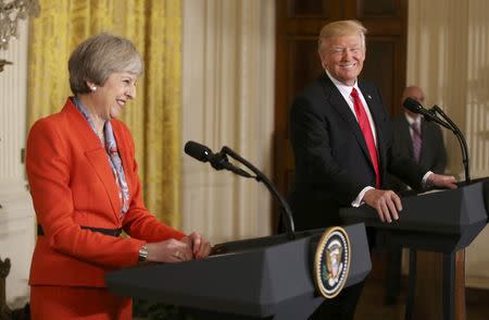 U.S. President Donald Trump and British Prime Minister Theresa May smile as they hold a joint news conference at the White House in Washington, U.S., January 27, 2017. REUTERS/Carlos Barria