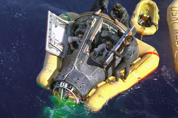 The Gemini 8 crew of Neil Armstrong and David Scott are seen being recovered from the Pacific Ocean after splashing down from space in March 1966.