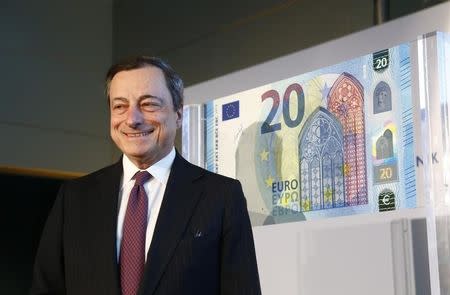 President of the European Central Bank (ECB) Mario Draghi presents the new 20 Euro banknote at the ECB headquarters in Frankfurt February 24, 2015. REUTERS/Ralph Orlowski