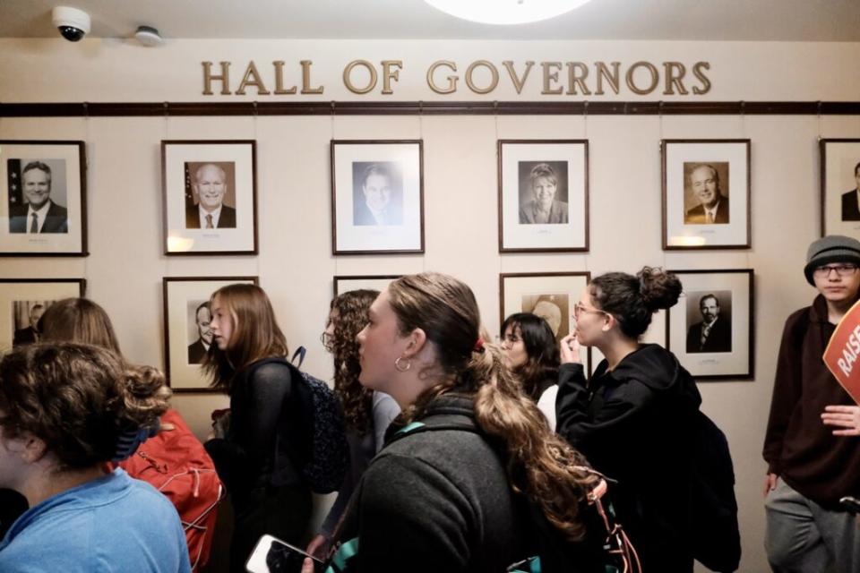 Students file past Gov. Mike Dunleavy's offices in the state Capitol as they protest his veto of a wide ranging education bill on April 4, 2024. (Photo by Claire Stremple/Alaska Beacon)