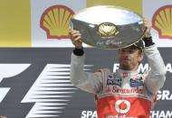 McLaren Mercedes' driver Jenson Button celebrates on the podium at the Spa-Francorchamps circuit in Spa during the Belgium Formula One Grand Prix. Button claimed his second win this year and 14th of his career when he drove to a comprehensive victory in an incident and accident-packed Belgian Grand Prix