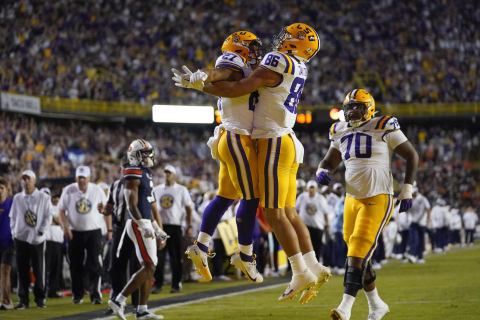 LSU running back Josh Williams (27) celebrates his touchdown carry with tight end Mason Taylor (86) in the second half of an NCAA college football game against Auburn in Baton Rouge, La., Saturday, Oct. 14, 2023. LSU won 48-18. (AP Photo/Gerald Herbert)