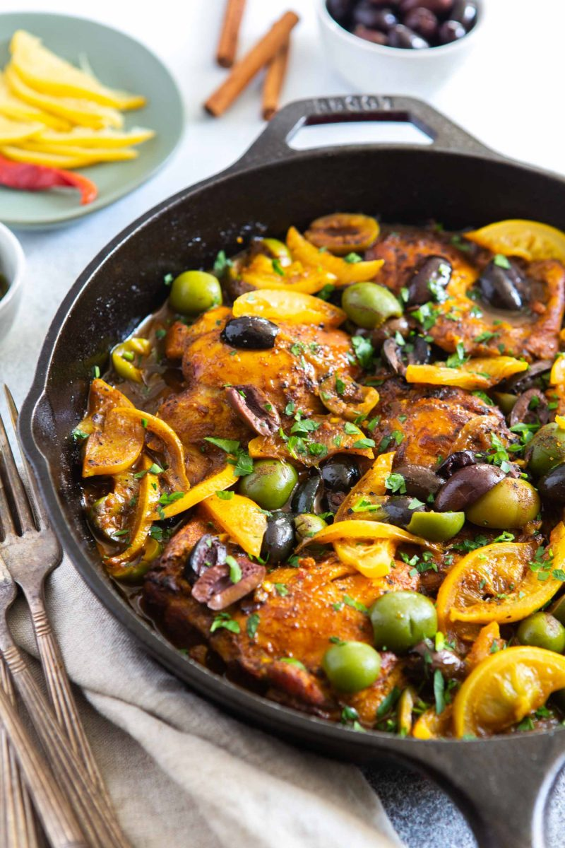 A skillet of chicken with olives and preserved lemons