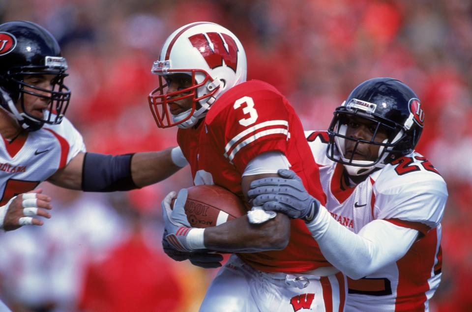 6 Oct 2001: Lee Evans #3 of Wisconsin Badgers gets tackled by Sharrod Wallace #22 of the Indiana Hoosiers during the game at the Camp Randall Stadium in Madison, Wisconsin. The Hoosiers defeated the Badgers 63-32.Mandatory Credit: Matthew Stockman /Allsport