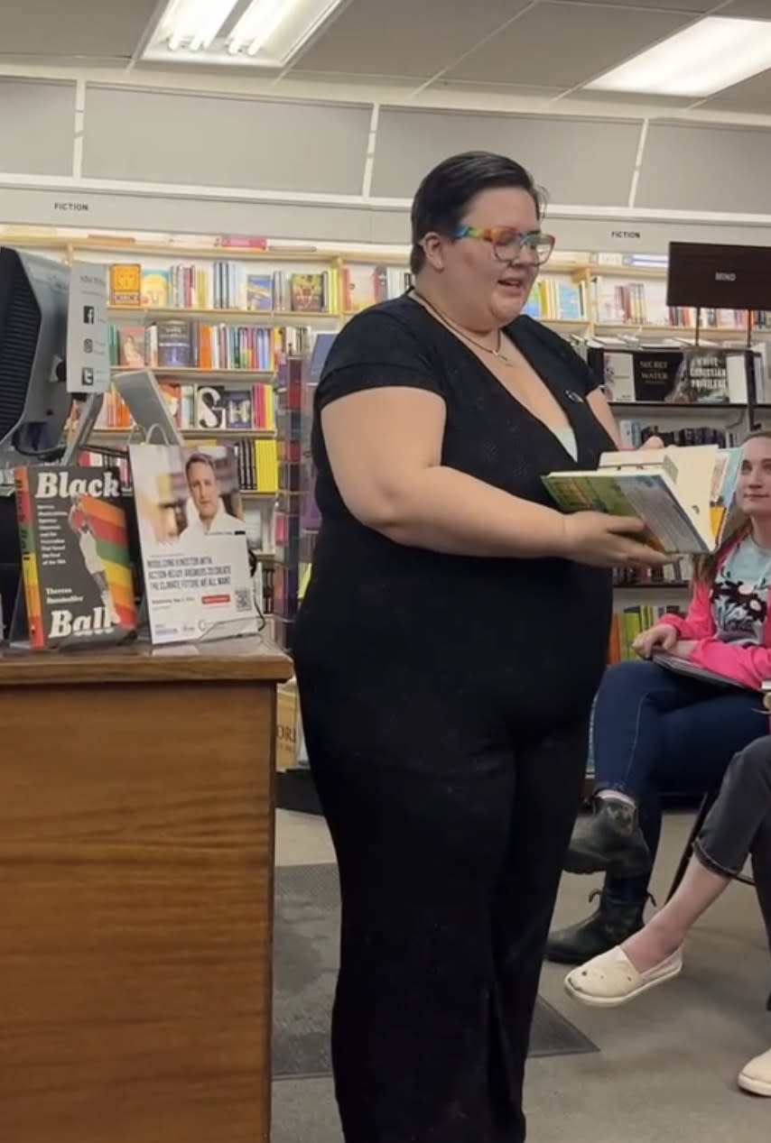 Author Ronnie Riley reading an excerpt from Jude Saves the World at one of their book signings