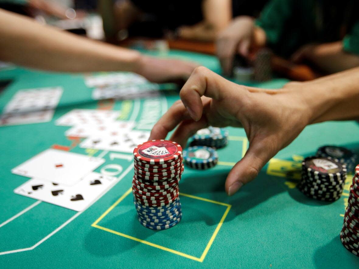 Police say five people have been charged following allegations that a table games dealer was in collusion with patrons at Woodbine Casino last year.  (Toru Hanai/Reuters - image credit)