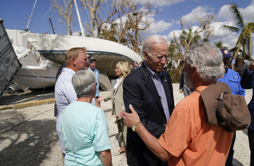 FILE - President Joe Biden talks to a person impacted by Hurricane Ian as he tours the area on Wednesday, Oct. 5, 2022, in Fort Myers Beach, Fla. (AP Photo/Evan Vucci, File)