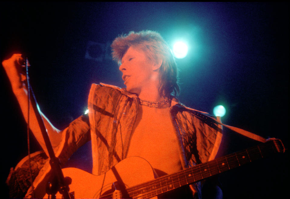 David Bowie performs onstage during his "Ziggy Stardust" era in 1973 in Los Angeles, California. (Photo by Michael Ochs Archives/Getty Images)