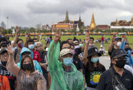 Pro-democracy protesters raise a three-fingers, symbol of resistance salute during a rally at Sanam Luang in Bangkok, Thailand, Sunday, Sept. 20, 2020. Thousands of demonstrators who occupied a historic field in Thailand's capital overnight continued with their rally on Sunday to support the demands of a student-led protest movement for new elections and reform of the monarchy. (AP Photo/Gemunu Amarasinghe)