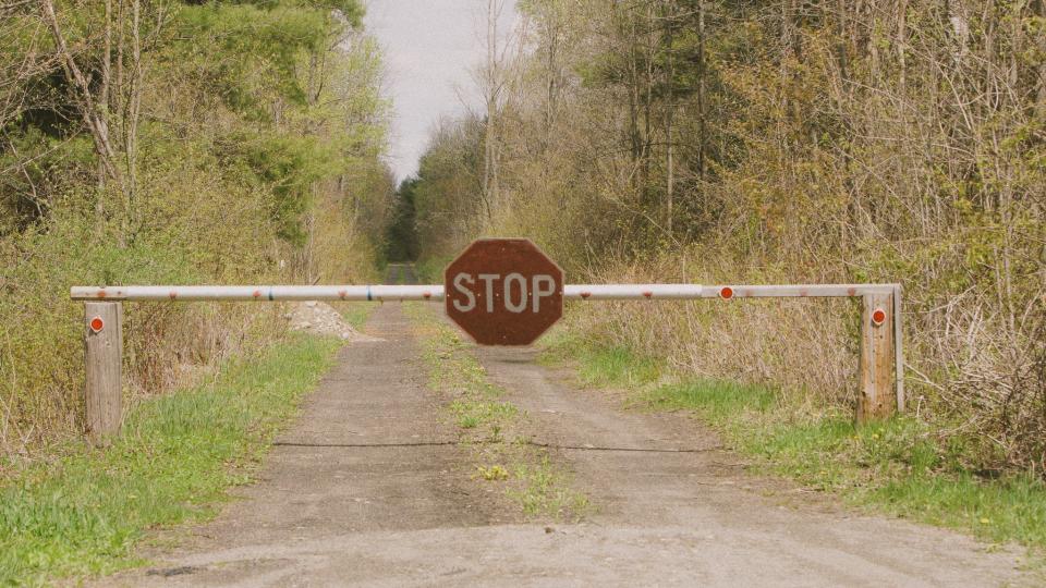 A stop sign marks the border between the U,S. and Canada in rural New York.