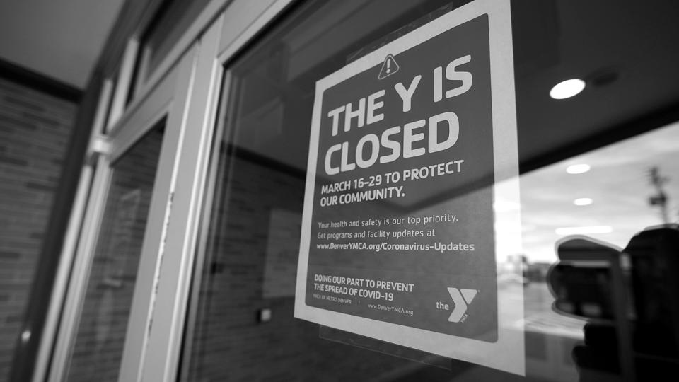 A sign hangs on the door to the Schlessmann YMCA as gyms have been forced to close in Colorado's efforts to fend off the spread of coronavirus on March 16, 2020, in Denver. (David Zalubowski/AP)