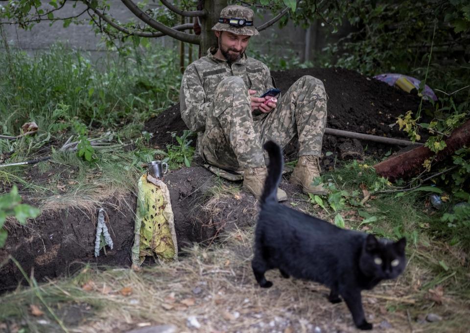 A Ukrainian serviceman rests at his positions at a front line near a Russian border in a Kharkiv region (Reuters)