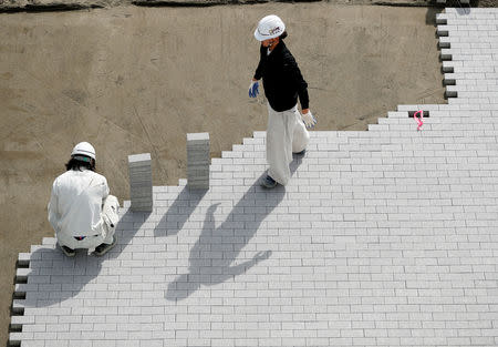 Workers are seen at the construction site of the Sea Forest Waterway for Tokyo 2020 Olympic and Paralympic games in Tokyo, Japan February 12, 2019. REUTERS/Issei Kato