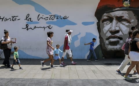 The legacy of Hugo Chavez still dominates Venezuela - Credit:  LUIS ROBAYO/ AFP