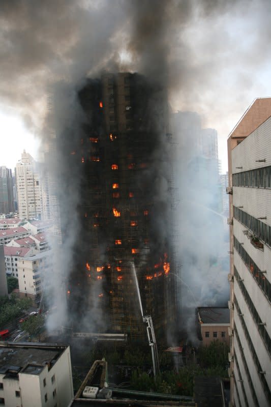 A fire in a high-rise Shanghai apartment building, primarily a home for teachers, killed more than 40 people and injured dozens on November 15, 2010. File Photo by {link:Peijin Chen/Flickr:"https://www.flickr.com/photos/cpj/5178106136/" target="_blank"}